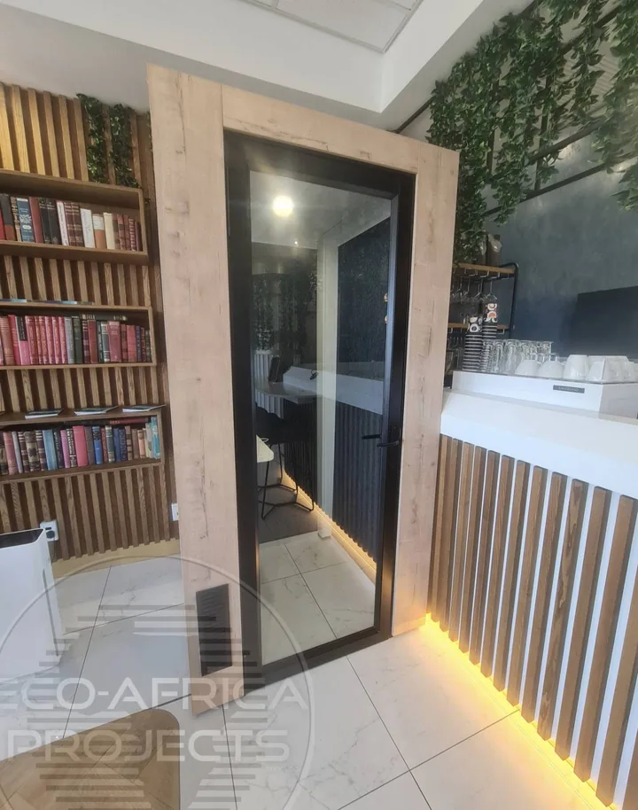 Black aluminium-framed solid glass door in a commercial space