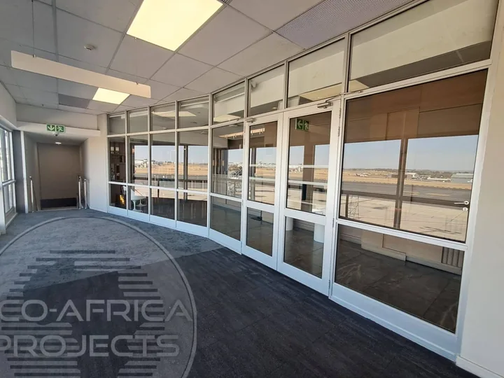 Large commercial interior with aluminium-framed glazing and doors