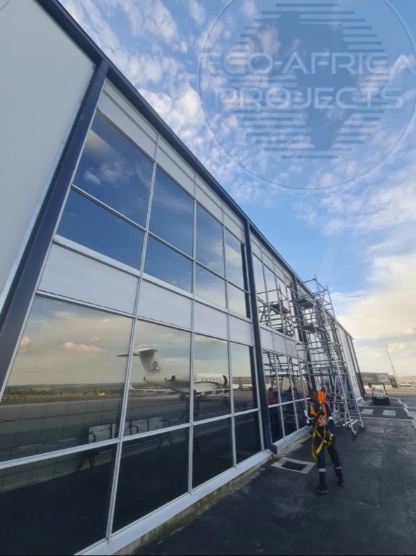 Commercial aluminium and glass façade during installation, with scaffolding alongside the glazing
