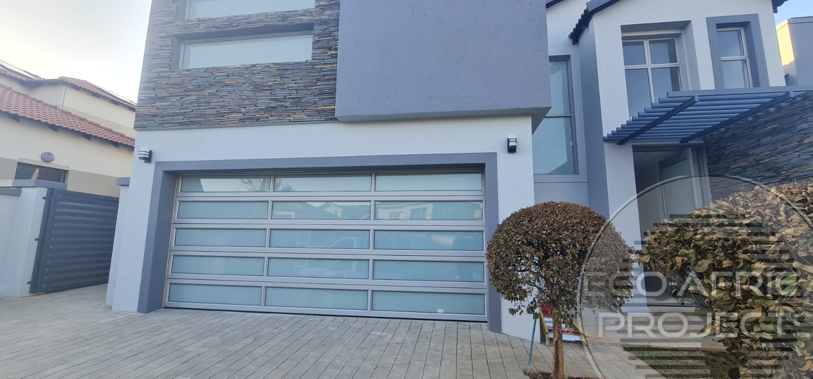 Custom aluminium-framed garage door with glazing