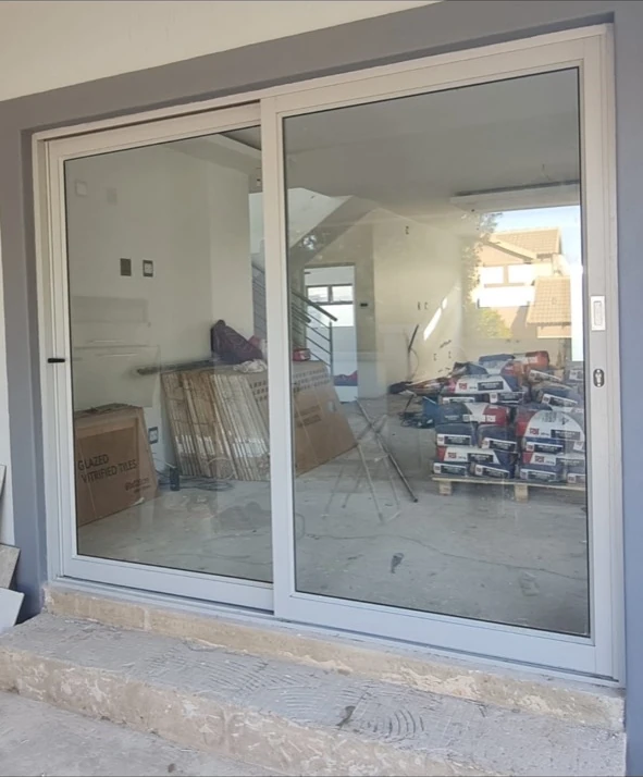 White heavy-duty Palace sliding door at a residential project under construction