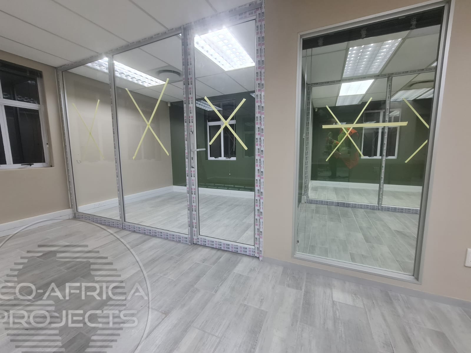 Existing aluminium-framed office partitions ready for adjustment and maintenance